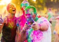 Guys with a girl celebrate holi festival Royalty Free Stock Photo
