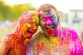 Guys with a girl celebrate holi festival Royalty Free Stock Photo