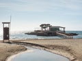 Guys in lifeguard tower and watch bay with island restaurat