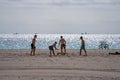 Guys playing Spikeball on the beach Miami Spring Break scene