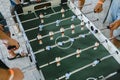 Guys are playing table football view from above. table football soccer with white and blue players