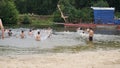 Guys relax on the beach standing on the shore