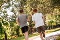 Guys running in park with backs to camera