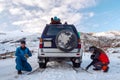 Guys set on a car tire chains, for driving on slippery roads Royalty Free Stock Photo