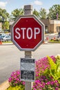 Fancy wooden stop sign frame and pole in a retail strip mall