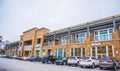 A shopping plaza and cars parked at open stores during covid-19