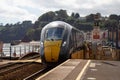 A GWR train passes through Dawlish railway station in Devon Royalty Free Stock Photo