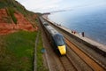 A GWR train travels along the sea wall at Dawlish, Devon Royalty Free Stock Photo