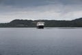 A ferry approaching a port on the coast of Scotland on a cold summers day. Royalty Free Stock Photo