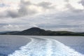 The wake left by a ferry travelling along the coast of Scotland on a cold summers day. Royalty Free Stock Photo