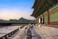 Gyeongbokgung Palace the famous landmark of South Korea before closing time with the traveler in the sunset sky Royalty Free Stock Photo