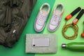 Gym bag and sports equipment on green background, flat lay Royalty Free Stock Photo