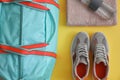 Gym bag and sports equipment on yellow background Royalty Free Stock Photo