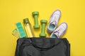 Gym bag and sports equipment on yellow background, flat lay Royalty Free Stock Photo