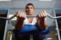 Gym bench, barbell exercise and man focus on muscle growth, strength training or lifting weights, curling or