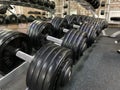 Gym for bodybuilding. Heavy dumbbells and exercise equipment. Barbells and equipment for athletes