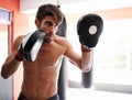 Gym, boxing and man with sparring pads for fitness, exercise and mixed martial arts training. Sports, fight and