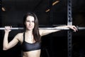 In the gym a brunette in sportswear. She poses Photo after filter processing