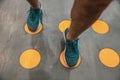 Close up of a mans legs on marking cirlces in a gym