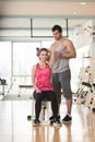 Gym Coach Helping Woman On Triceps Exercise Royalty Free Stock Photo