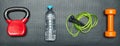 Gym concept. dumbbell, skipping rope,training weight and bottle of water on step equipment background.Healthy lifeslile