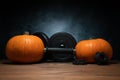 Gym dumbbell barbell with autumn pumpkins as a weight plates. Royalty Free Stock Photo