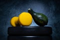 Gym dumbbell, small decorative pumpkin, gourd or squash on a barbell weight plates. Fitness autumn.