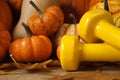 Gym dumbbells and small decorative pumpkins, gourds or squash types.