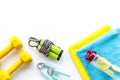 Gym equipment - dumbbells, jump rope - frame on white background top-down copy space Royalty Free Stock Photo