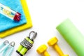 Gym equipment - dumbbells, jump rope - frame on white background top-down copy space Royalty Free Stock Photo