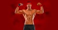 Happy man athlete with dumbbell on red background. Gym full body workout. Muscular man athlete in fitness gym have havy