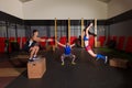 Gym group workout barbells slam balls and jump