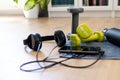 Gym at home, accessories for fitness at home. Tools for sport activities: towel, headphone, mobile phone, dumbbell and water tank