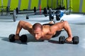 Gym man push-up strength pushup exercise with dumbbell Royalty Free Stock Photo