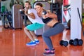 Gym man and woman push-up strength pushup with dumbbell in a workout Royalty Free Stock Photo