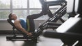 In the gym - muscular man exercising on leg press machine Royalty Free Stock Photo