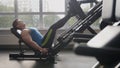 In the gym - muscular man exercising on leg press machine Royalty Free Stock Photo