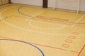 Gym for playing futsal, mini-football. Folded wooden parquet on the field of hall for mini-football. Futsal ball and bright line Royalty Free Stock Photo