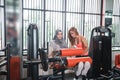 Gym seated leg curl machine exercise muslim women hijab Royalty Free Stock Photo