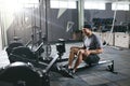 Gym. Sports Man Training On Rowing Machine Royalty Free Stock Photo