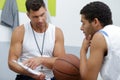 gym teacher with basketball player