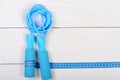 Gym tools in cyan blue on wooden backdrop