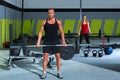 Gym with weight lifting bar workout man and woman Royalty Free Stock Photo