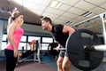 Gym weightlifting couple workout barbell dumbbell Royalty Free Stock Photo