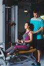 Gym woman and her trainer doing exercise at the gym Royalty Free Stock Photo