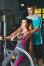 Gym woman and her trainer doing exercise at the gym Royalty Free Stock Photo