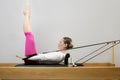 Gym woman pilates stretching sport in reformer bed Royalty Free Stock Photo