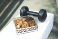 Gym workout food organic healthy mix dry fruits with dumbbell golden and black raisins dates almonds