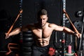 Young strong focused fit muscular man chest stretching workout in improvised gym with rubber for strength and good looking of musc Royalty Free Stock Photo