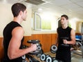 Gym young man posing bodybuilding weigths